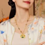 Model wearing a natural Tahitian black pearl pendant necklace with 18k gold plated chain